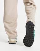 New Balance 574 Sneakers in Dark Green and Off White